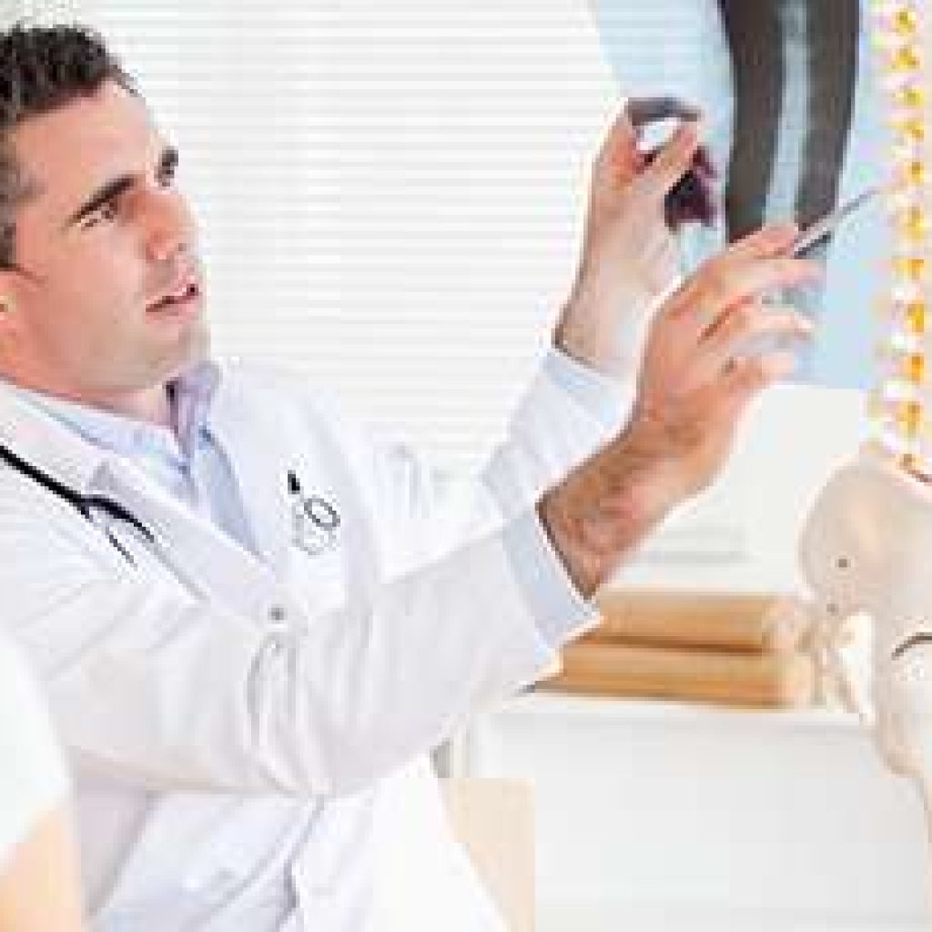 Male Doctor showing a patient a x-ray