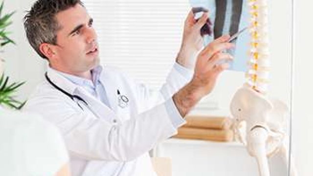 Male Doctor showing a patient a x-ray